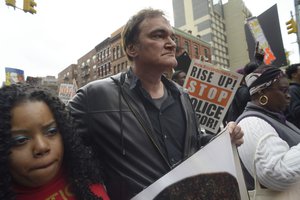 Director Quentin Tarantino, center, participates in a rally to protest against police brutality Saturday, Oct. 24, 2015, in New York.