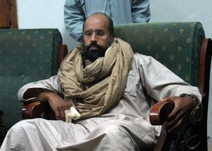 In this Saturday, Nov. 19, 2011 file photo, Seif al-Islam is seen after his capture in the custody of revolutionary fighters in Zintan, Libya.