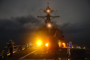 File - ailors aboard the Arleigh Burke-class guided-missile destroyer USS Lassen (DDG 82) conduct a man-overboard drill in the South China Sea, 28 September, 2015.