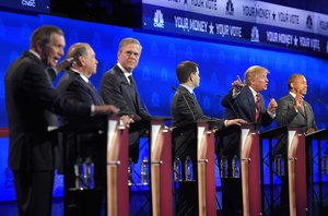 John Kasich, left, and Donald Trump, second from right, argue across fellow candidates during the CNBC Republican presidential debate at the University of Colorado, Wednesday, Oct. 28, 2015, in Boulder, Colo.