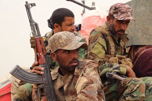 In this Monday, June 1, 2015 file photo, fighters from the Badr Brigades Shiite militia patrol at the front line in the fight against Islamic State militants on the outskirts of Fallujah in Anbar province, Iraq.