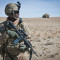 In this March 9, 2012 photograph, a U.S. soldier with an autmatic weapon watches as members of the Afghan National Army set up a check point in a desert valley in Afghanistan. (Flickr / DVIDSHUB / Sgt. Ken Scar)