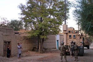 File - U.S., Czech and Afghan soldiers patrol and clear routes through a village in Parwan province, Afghanistan, Oct. 20, 2015. The U.S. soldiers are assigned to the 10th Mountain Division.