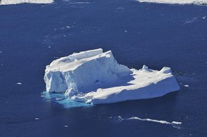 File - An iceberg is seen out the window of NASA's DC-8 research aircraft as it flies 2,000 feet above the Amundsen Sea in West Antarctica on Wednesday, Oct., 21, 2009. This was taken on the fourth science flight of NASA's Operation Ice Bridge airborne Earth science mission to study Antarctic ice sheets, sea ice, and ice shelves.