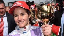 "I want to say to everyone else, get stuffed, because women can do anything and we can beat the world." Michelle Payne, the first woman to ride the winner of the Melbourne Cup holds the trophy.