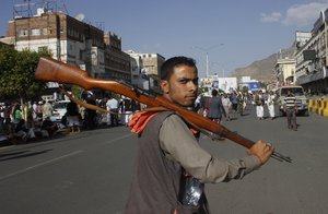 A Houthi Shiite rebel carries his weapon as he joins others to protest against Saudi-led airstrikes, during a rally in Sanaa, Yemen, Wednesday, April 1, 2015.