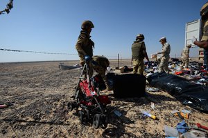 In this Russian Emergency Situations Ministry photo, made available on Monday, Nov. 2, 2015 Egyptian soldiers collect personal belongings of plane crash victims at the crash site of a passenger plane bound for St. Petersburg in Russia that crashed in Hassana, Egypt's Sinai Peninsula, on Monday, Nov. 2, 2015.