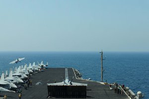 File - An F/A-18F Super Hornet, attached to the Red Rippers of Strike Fighter Squadron 11, prepares to launch off the flight deck aboard the aircraft carrier USS Theodore Roosevelt, supporting Operation Inherent Resolve strike operations in Iraq and Syria, Sept. 14, 2015.