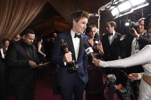 File - Eddie Redmayne poses with the award for best actor in a leading role for “The Theory of Everything” at the Governors Ball after the Oscars on Sunday, Feb. 22, 2015, in Los Angeles.