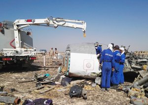 Russian Emergency Ministry experts work at the crash site of a Russian passenger plane bound for St. Petersburg in Russia that crashed in Hassana, Egypt's Sinai Peninsula, on Monday, Nov. 2, 2015.