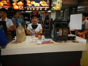 File - A McDonald's employee takes an order in Quezon City, the Philippines.