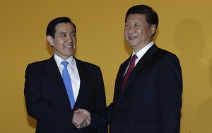 Chinese President Xi Jinping, right, and Taiwanese President Ma Ying-jeou, left, shake hands at the Shangri-la Hotel on Saturday, Nov. 7, 2015, in Singapore