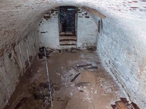 This Nov. 3, 2015 photo provided by the New York City Department of Design and Construction shows the inside of a centuries-old burial vault containing human remains beneath a street in New York's Greenwich Village neighborhood according to anthropologists and archeologists. Two vaults were discovered by workers replacing a water main in the heart of New York University's campus. One of the roughly 15-by-18-foot crypts contained skeletons and skulls of between 9 and 12 people pushed into a corner while more than a dozen stacked wooden coffins can be seen in the second one.