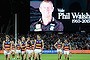 Flood of emotion: Adelaide players walk from the field after round 16, as a tribute is paid to coach Phil Walsh. 