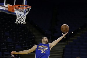 Golden State Warriors' Stephen Curry reaches for the ball during NBA basketball practice, Wednesday, June 3, 2015, in Oakland