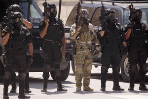 In this Thursday, June 20, 2013 file photo, special operations forces from Iraq, Jordan and the U.S. stand in formation wearing gas masks following a combined demonstration as part of Eager Lion multinational military maneuvers at the King Abdullah Special Operations Training Center (KASOTC) in Amman, Jordan.