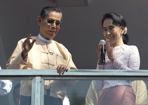 Leader of Myanmar's National League for Democracy party, Aung San Suu Kyi delivers a speech with party patron Tin Oo from a balcony of the NLD headquarters in Yangon, Myanmar, Monday, Nov. 9, 2015.