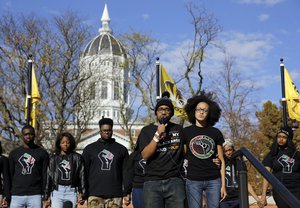 Jonathan Butler, front left, addresses a crowd following the announcement that University of Missouri System President Tim Wolfe would resign Monday, Nov. 9, 2015, at the university in Columbia, Missouri.