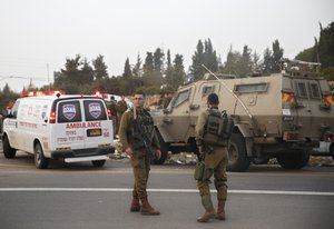 File - Israeli soldiers stand guard at the Halhul junction, north of the West Bank city of Hebron, Wednesday, Nov. 4, 2015.