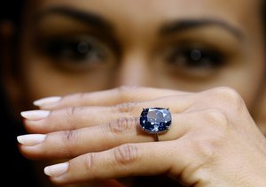 File - Model Charlene Bonnithon displays the rare Blue Moon Diamond at Sotheby's auction rooms in London, Thursday, Sept. 17, 2015.