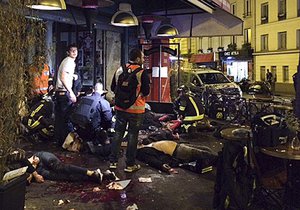 Victims of a shooting attack lay on the pavement outside La Belle Equipe restaurant in Paris Friday, Nov. 13, 2015. Well over 100 people were killed in Paris on Friday night in a series of shooting, explosions.