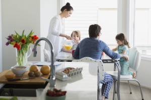 Family in pajamas enjoying breakfast in breakfast nook Family, generic family at home, family in the kitchen