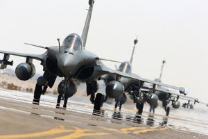 This photo released on Sunday, Sept. 27, 2015 by the French Army Communications Audiovisual office (ECPAD) shows French army Rafale fighter jets on the tarmac of an undisclosed air base as part of France's Operation Chammal launched in September 2015 in support of the US-led coalition against Islamic State group. Six French jet fighters targeted and destroyed an Islamic State training camp in eastern Syria in a five-hour operation on Sunday, President Francois Hollande announced, making good on a promise to go after the group that he has said is planning attacks against several countries, including France.