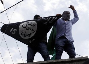 Protesters hold up a flag of the Islamic State of Iraq and the Levant (ISIL),shouts slogans during a protest against Israeli military operations in Gaza.