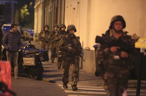 French soldiers patrol in Paris suburb Saint Denis, Wednesday, Nov.18, 2015.