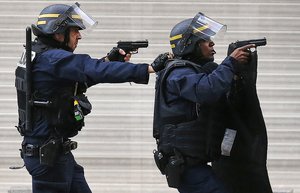 Police forces operate in Saint-Denis, a northern suburb of Paris, Wednesday, Nov. 18, 2015. Police say two suspects in last week's Paris attacks, a man and a woman, have been killed in a police operation north of the capital.