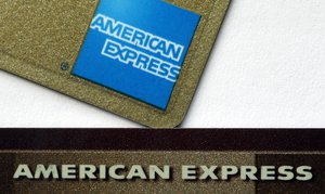 This Tuesday, Jan. 17, 2012 file photo shows two American Express cards in Surfside, Fla. American Express on Wednesday, Oct. 17, 2012 said its net income rose 1 percent in the third quarter as its customers spent more money, boosting revenue for the credit card issuer.