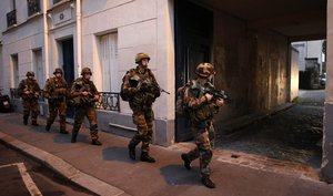 Soldiers operate in St. Denis, a northern suburb of Paris, Wednesday, Nov. 18, 2015.