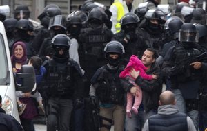 Residents are evacuated in Saint Denis, near Paris, Wednesday, Nov. 18, 2015.