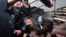 Cheerleaders applying hairspray