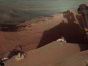 File - NASA's Mars Rover Opportunity catches its own late-afternoon shadow in this dramatically lit view eastward across Endeavour Crater on Mars.