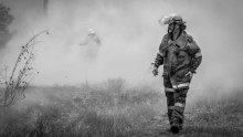 Darrin the firefighter watches an organised burn in Bundaberg, QLD