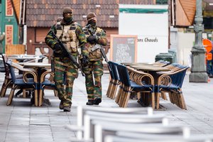 Belgian Army soldiers patrol near deserted terraces in the center of Brussels on Sunday, Nov. 22, 2015.