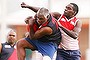 An inmate from the Bombers marks the ball against an inmate from the Swans team during a Scratch Match at Alice Springs Correctional Centre.