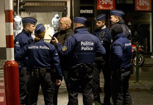 Police stand near a barricade during an operation in the center of Brussels on Sunday, Nov. 22, 2015. Western leaders stepped up the rhetoric against the Islamic State group on Sunday as residents of the Belgian capital awoke to largely empty streets and the city entered its second day under the highest threat level. With a menace of Paris-style attacks against Brussels and a missing suspect in the deadly Nov. 13 attacks in France last spotted crossing into Belgium, the city kept subways and underground trams closed for a second day.