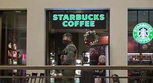 A Belgian Army soldier patrols outside a Starbucks coffee shop in the center of Brussels on Monday, Nov. 23, 2015. The Belgian capital Brussels has entered its third day of lockdown