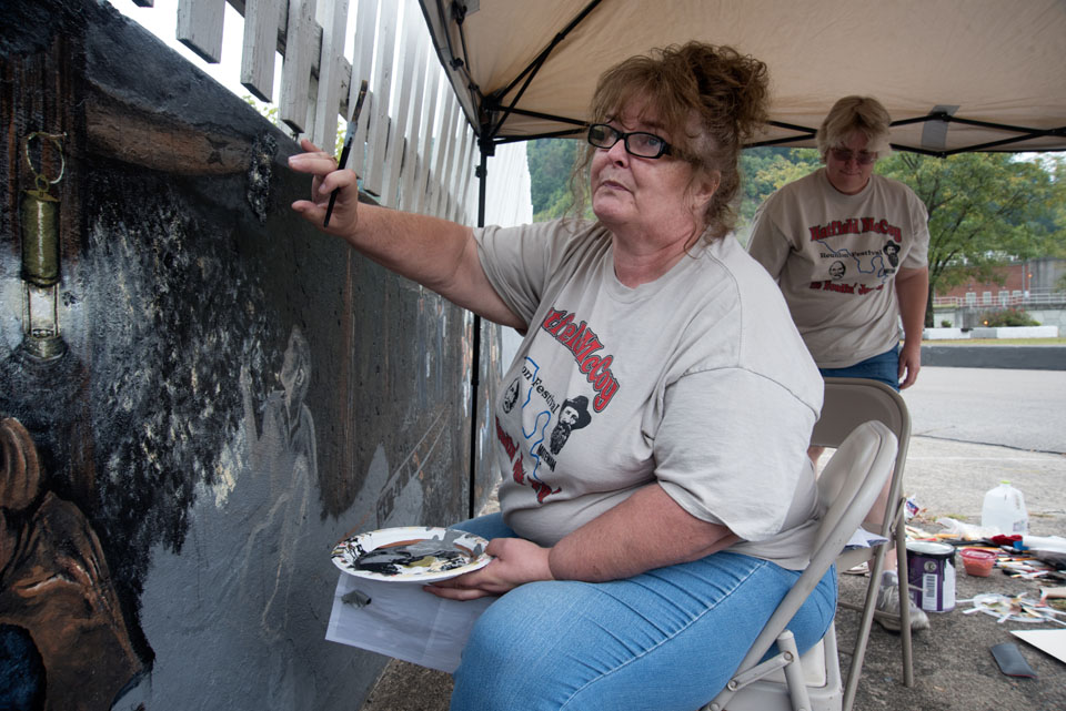 Woman painting mural