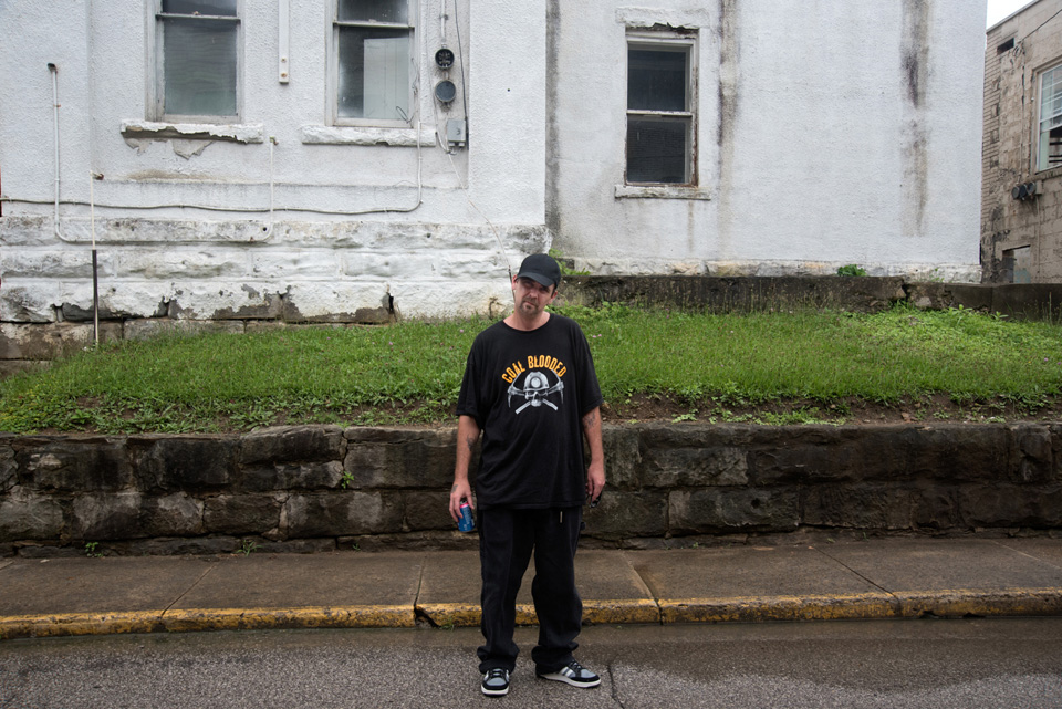 man wearing "coal blooded" shirt