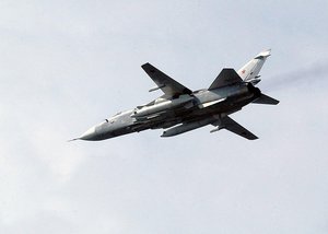 A Russian SU-24 Fencer fighter jet flies above the Aegis class, guided missile cruiser USS Vella Gulf (CG 72) during the maritime exercise Baltic Operations 2003 (BALTOPS).