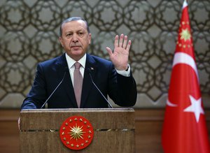 Turkish President Recep Tayyip Erdogan addresses a meeting of local administrators at his palace in Ankara, Turkey, Thursday, Nov. 26, 2015.