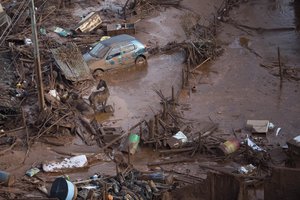 File - Horses struggle in the mud at the small town of Bento Rodrigues after a dam burst in Minas Gerais state, Brazil, Friday, Nov. 6, 2015.