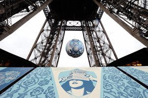 American street artist Shepard Fairey, aka Obey's, latest piece 'Earth Crisis', a giant sphere themed on environment hangs between the first and second floor of the Eiffel Tower in Paris, Friday, Nov. 20, 2015.