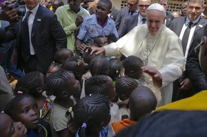 Pope Francis blesses children during his visit at a refugee camp, in Bangui, Central African Republic, Sunday, Nov. 29, 2015.