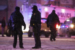 Police confer at an intersection near the scene of a shooting at a Planned Parenthood clinic Friday, Nov. 27, 2015, in Colorado Springs, Colorado.