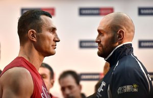 Challenger Tyson Fury watches world champion Wladimir Klitschko, left, after the Official Weigh-In in Essen, Germany, prior their heavyweight boxing fight, Friday, Nov. 27, 2015.