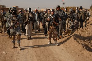 File - Iraqi Concerned Local Citizens, Iraqi National Police and U.S. Army Soldiers from Alpha Troop, 3rd Battalion, 1st Cavalry Regiment, 3rd Heavy Brigade Combat Team, 3rd Infantry Division clear a main roadway of improvised explosive devices outside of Hamidat, Iraq, Jan. 6, 2008